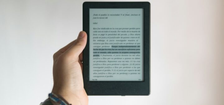 person holding black e book reader